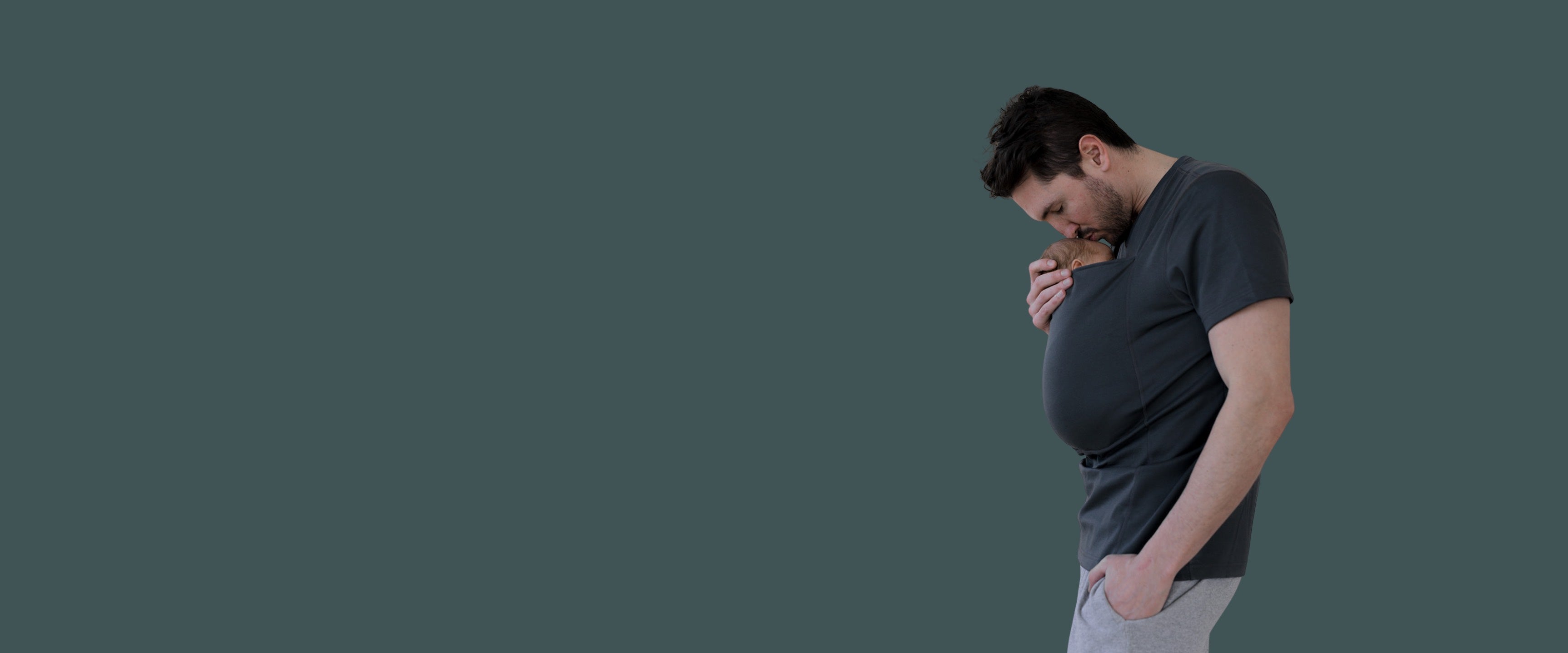 Dad kissing the baby in his Dad Shirt pouch.