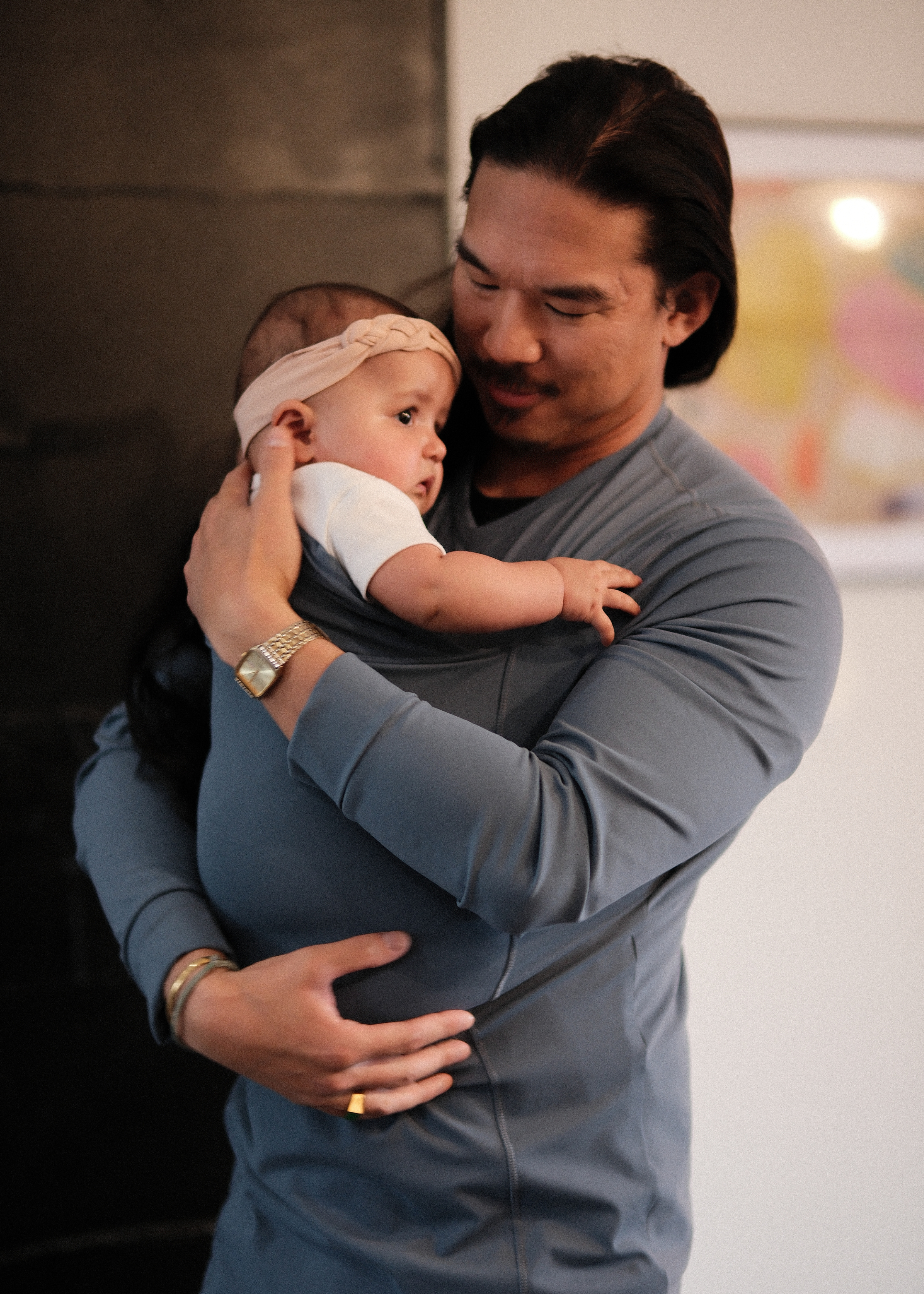 Dad wearing his baby in the pouch of his Long Sleeve Brook Dad Shirt.