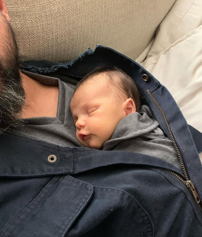 Dad wearing his baby in a Dad Shirt while getting things done