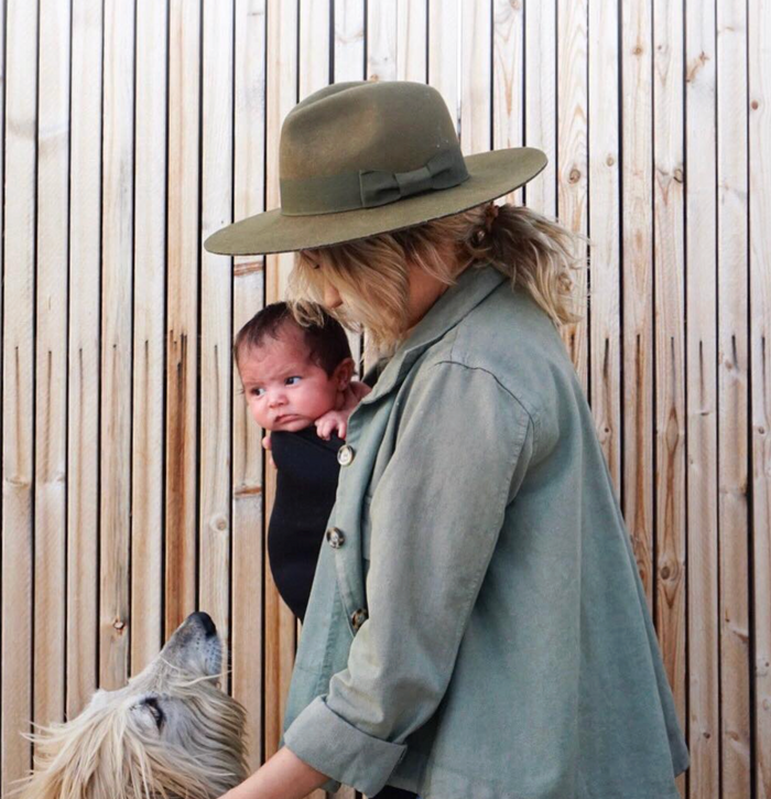 Mom carrying her baby in a Mom Shirt outdoors