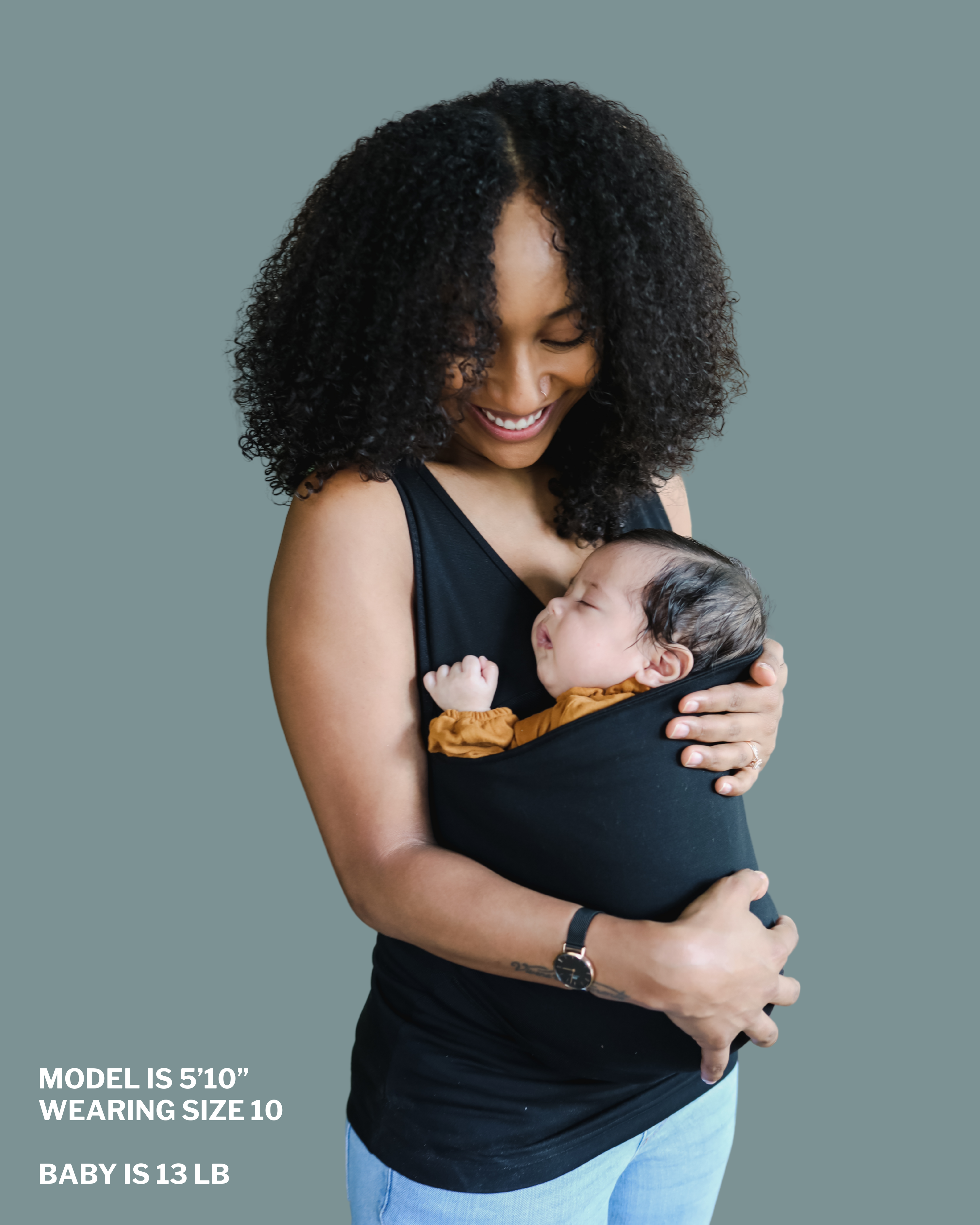 Mom snuggling baby in soothe shirt pouch. "Model is 5 ft 10 in, wearing size 10, baby is 13 lbs"