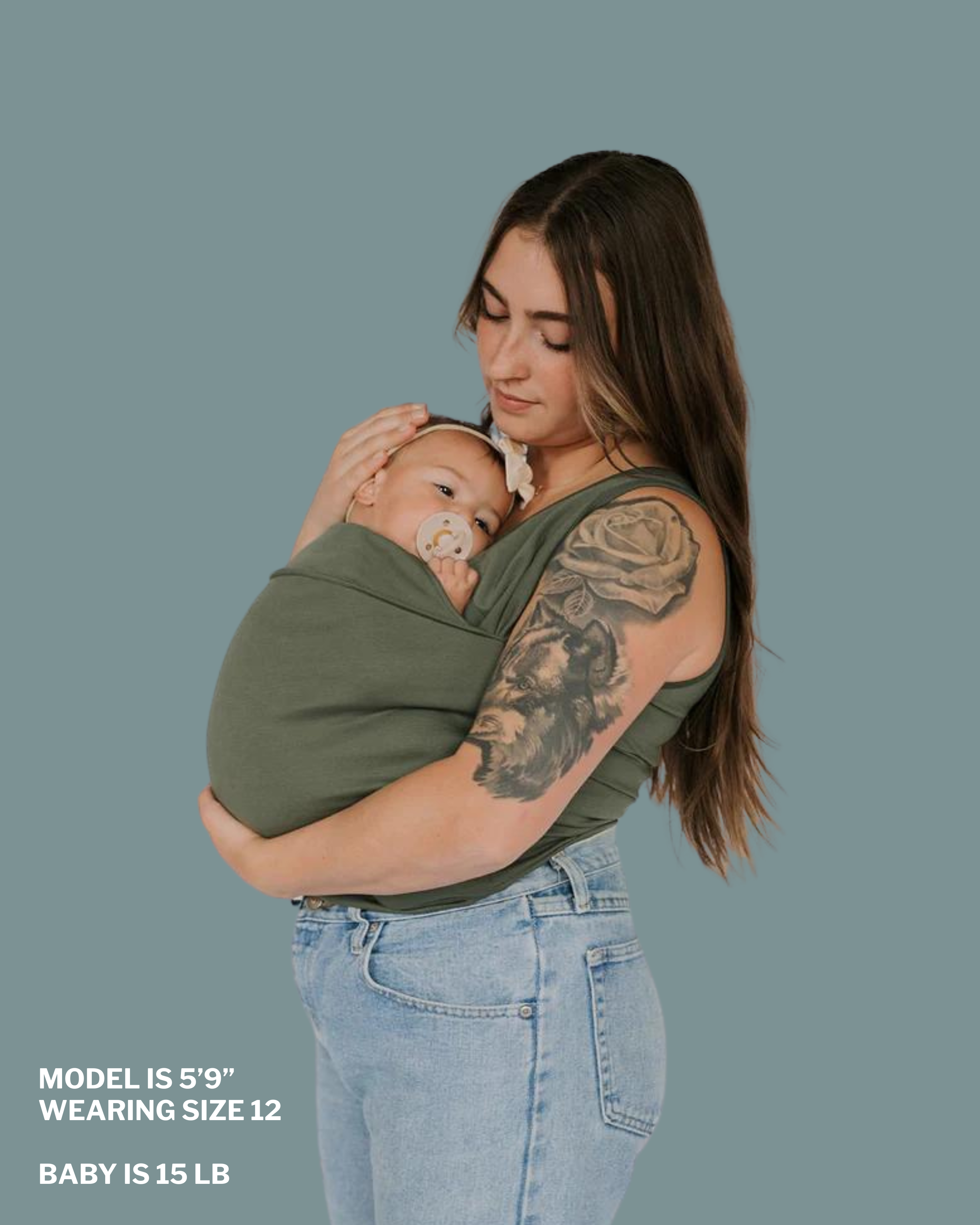 Mom snuggling baby in soothe shirt pouch. "Model is 5 ft 9 in, wearing size 12, baby is 15 lbs"