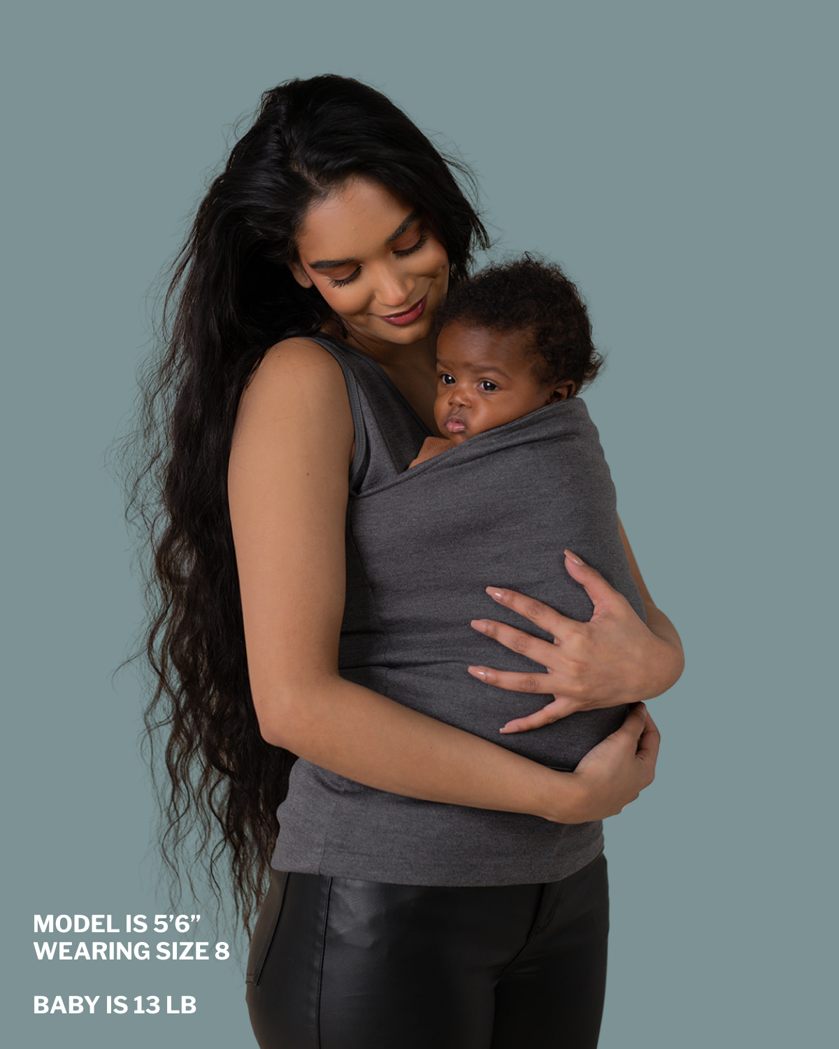 Mom snuggling baby in soothe shirt pouch. "Model is 5 ft 6 in, wearing size 8, baby is 13 lbs"