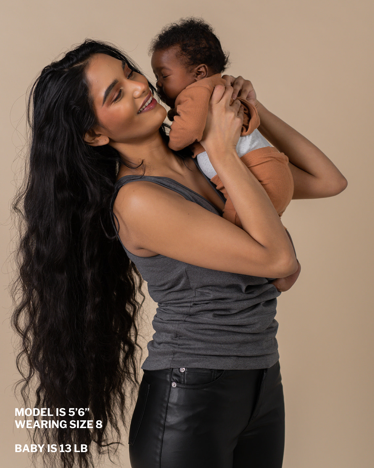 Mom in a gray soothe shirt with baby. "Model is 5 foot 6 inches, wearing size 8, baby is 13 lbs"