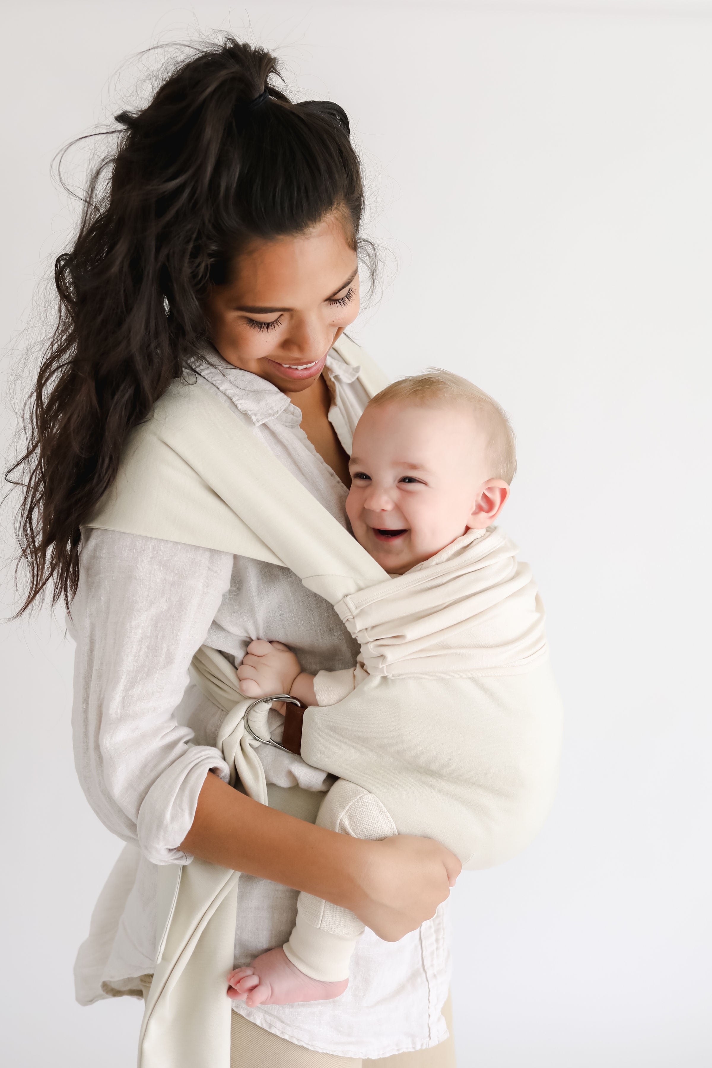 Side view of a female front carrying a baby in a Natural Simple Wrap.