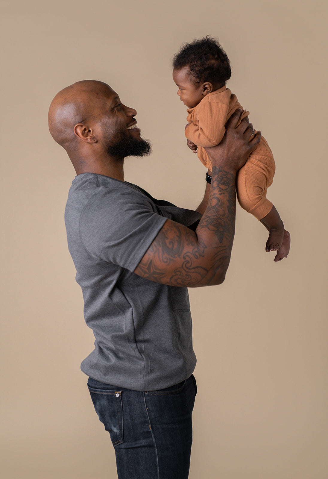 Dad holding baby after removing from pouch.