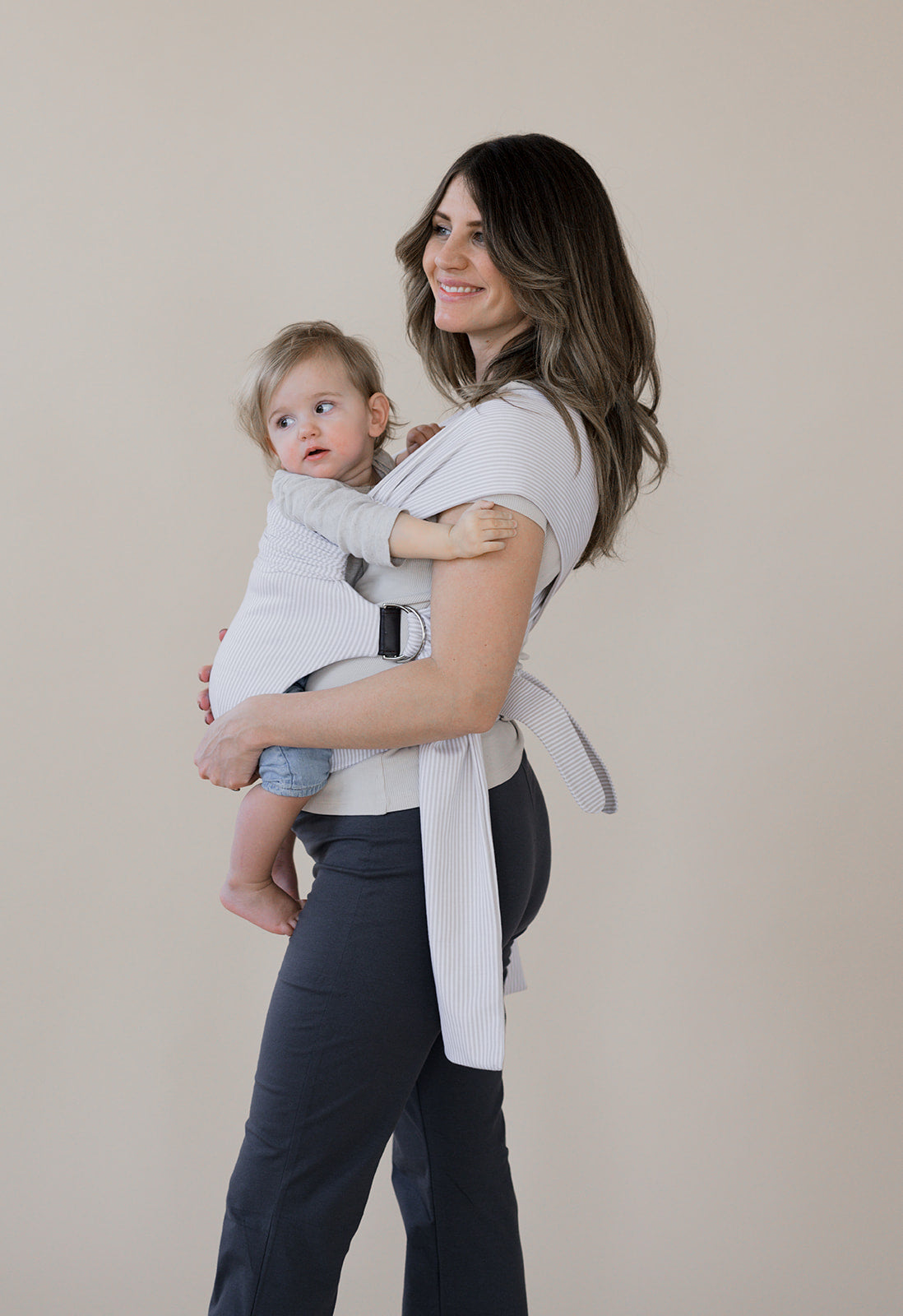 Pregnant mom front carrying her baby in an Oatmeal Stripe Simple Wrap.