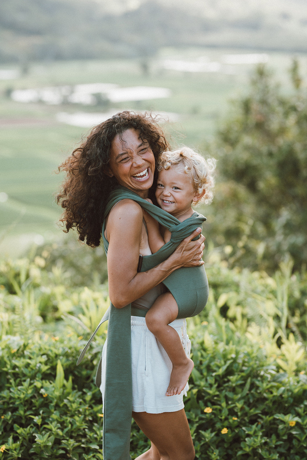 Female front carrying a toddler in a Fern Simple Wrap.