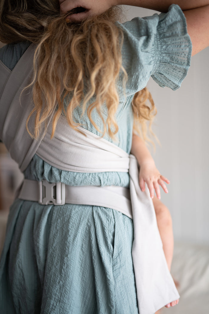 Toddler riding in a Simple Wrap on a dad's chest