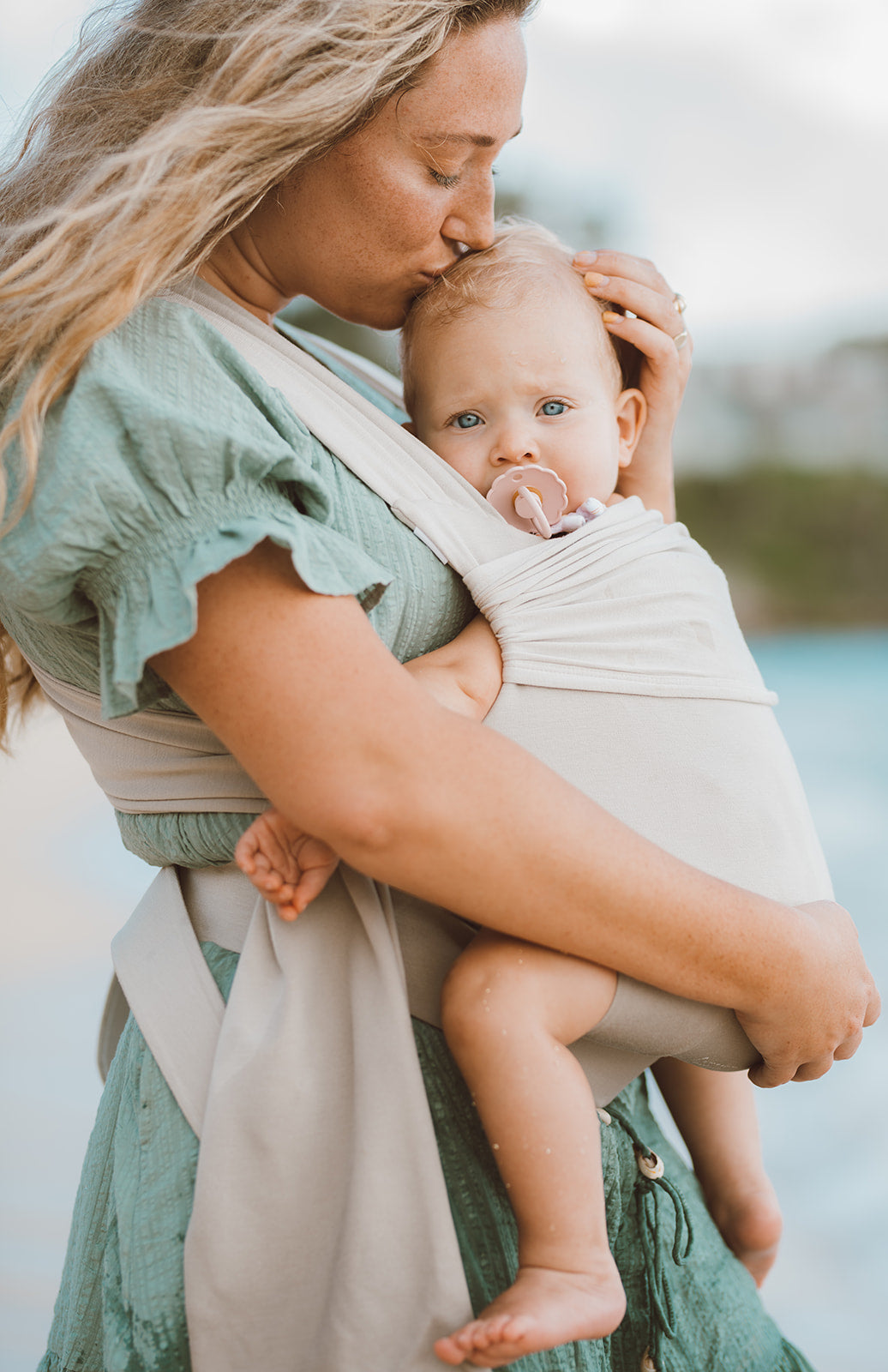 Female front carrying a baby in a Flax Simple Wrap.