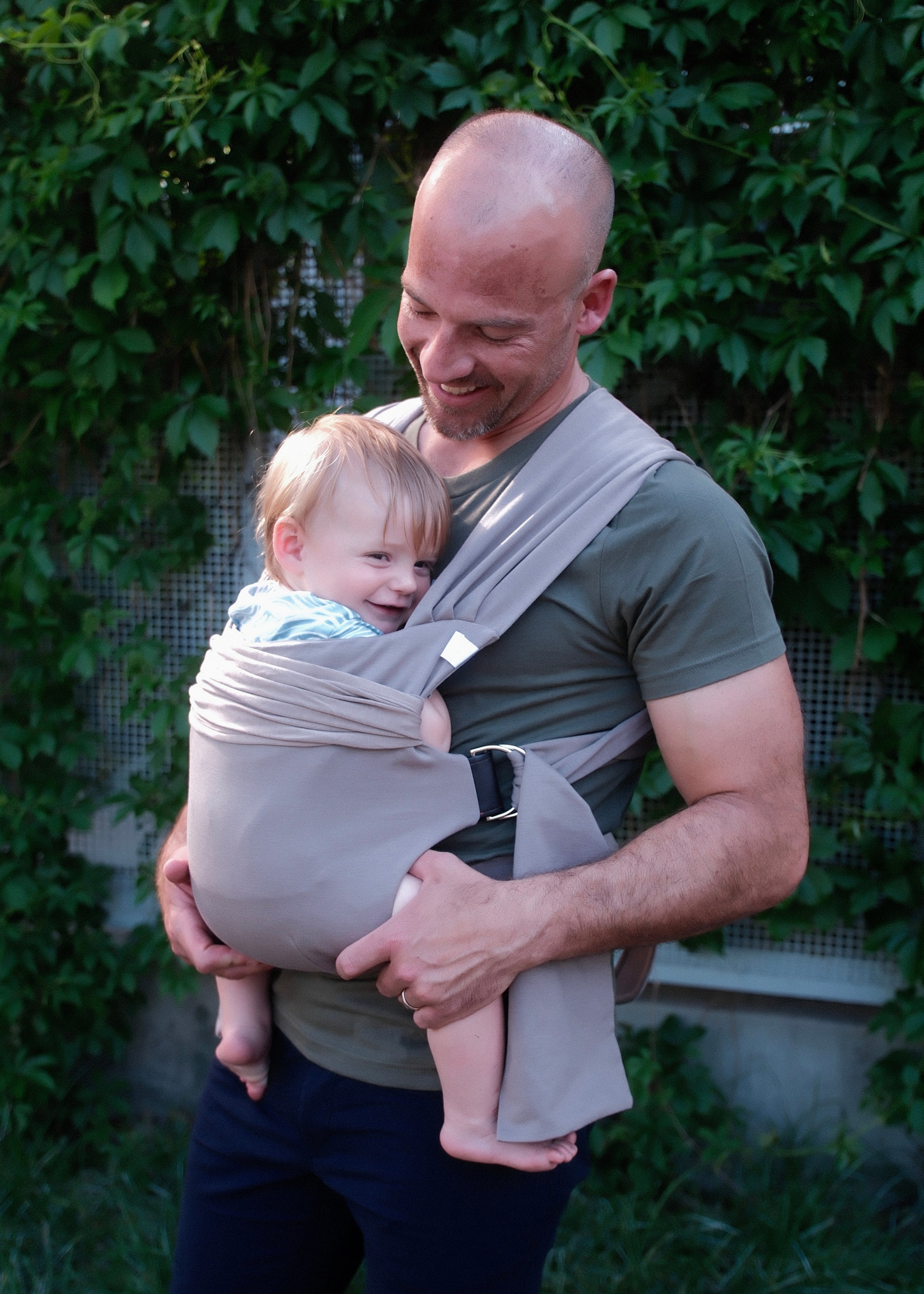 Dad front carrying a toddler in a Simple Wrap.