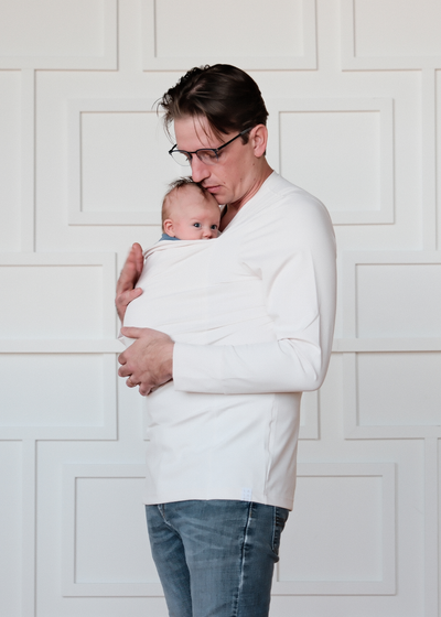 Dad wearing his newborn in the pouch of his Long Sleeve Natural Dad Shirt.