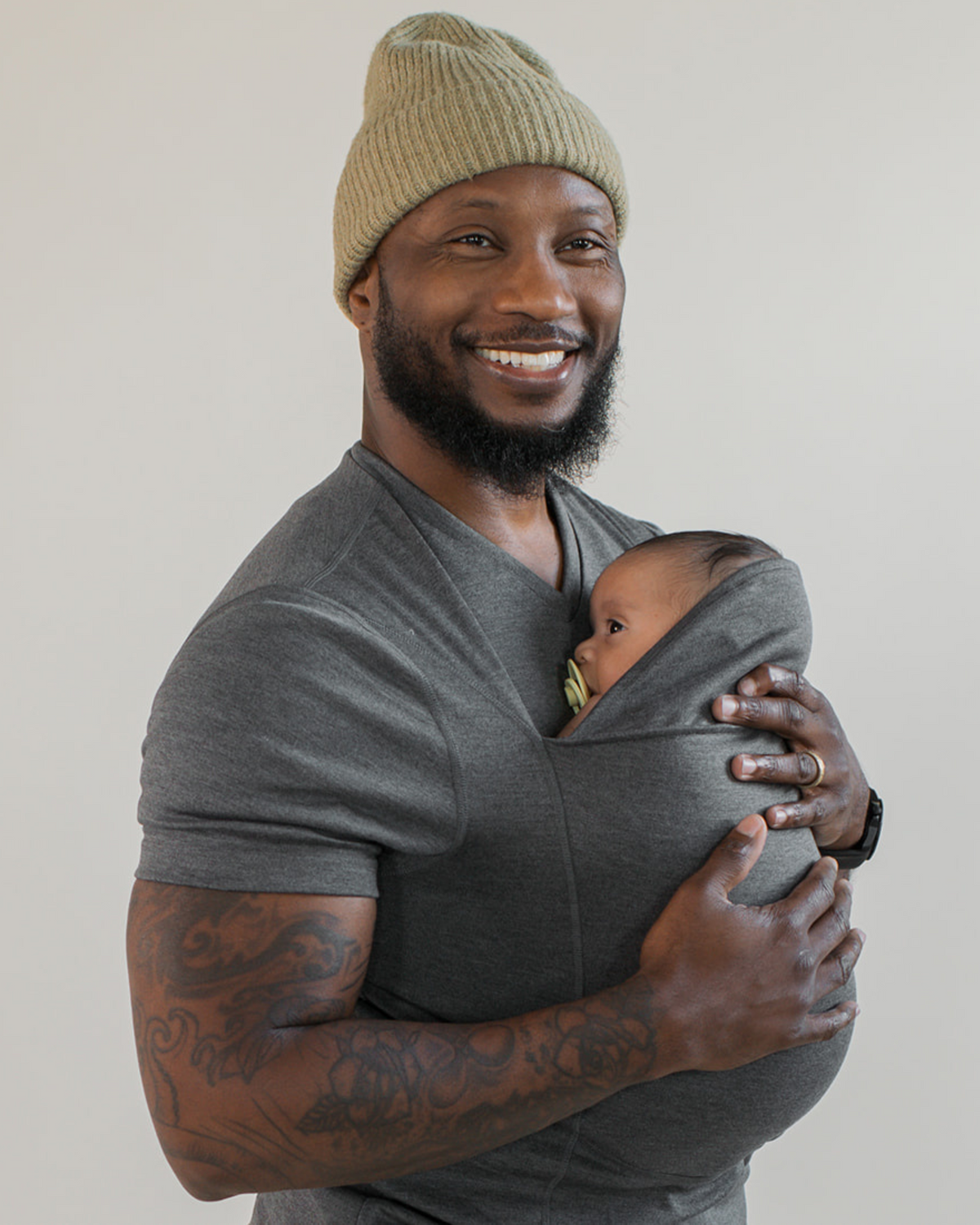 Dad snuggling the newborn in his Dad Shirt.