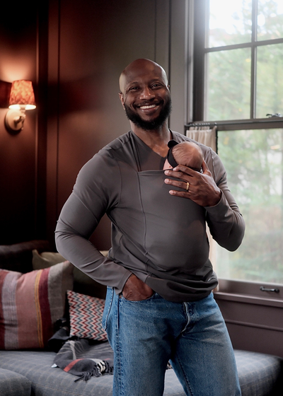Dad wearing his baby in a gray long sleeve Dad Shirt.