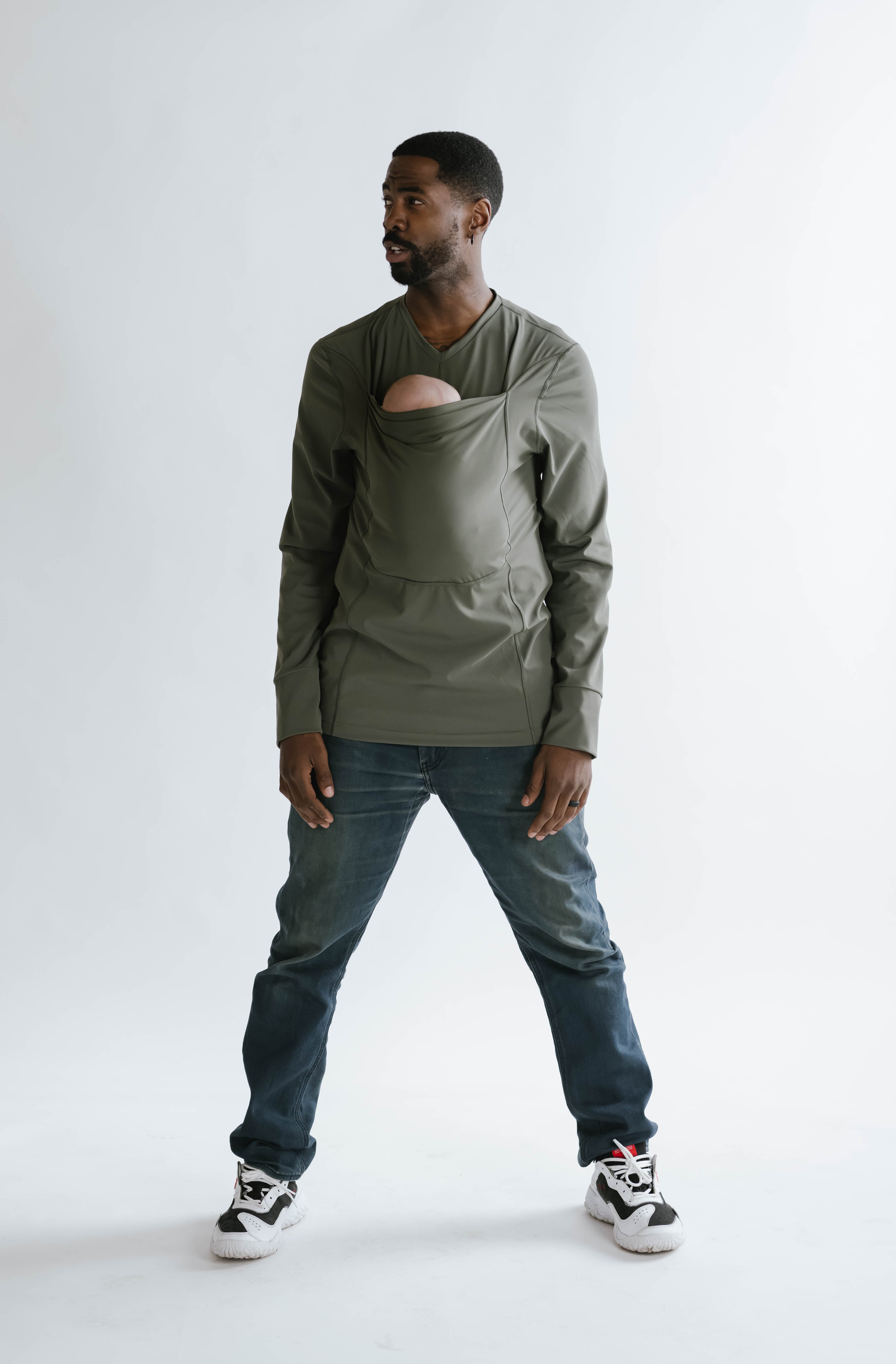 Male wearing a newborn in a long sleeve Fern Dad Shirt.