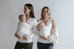 2 females wearing newborns in Natural Soothe Shirts.