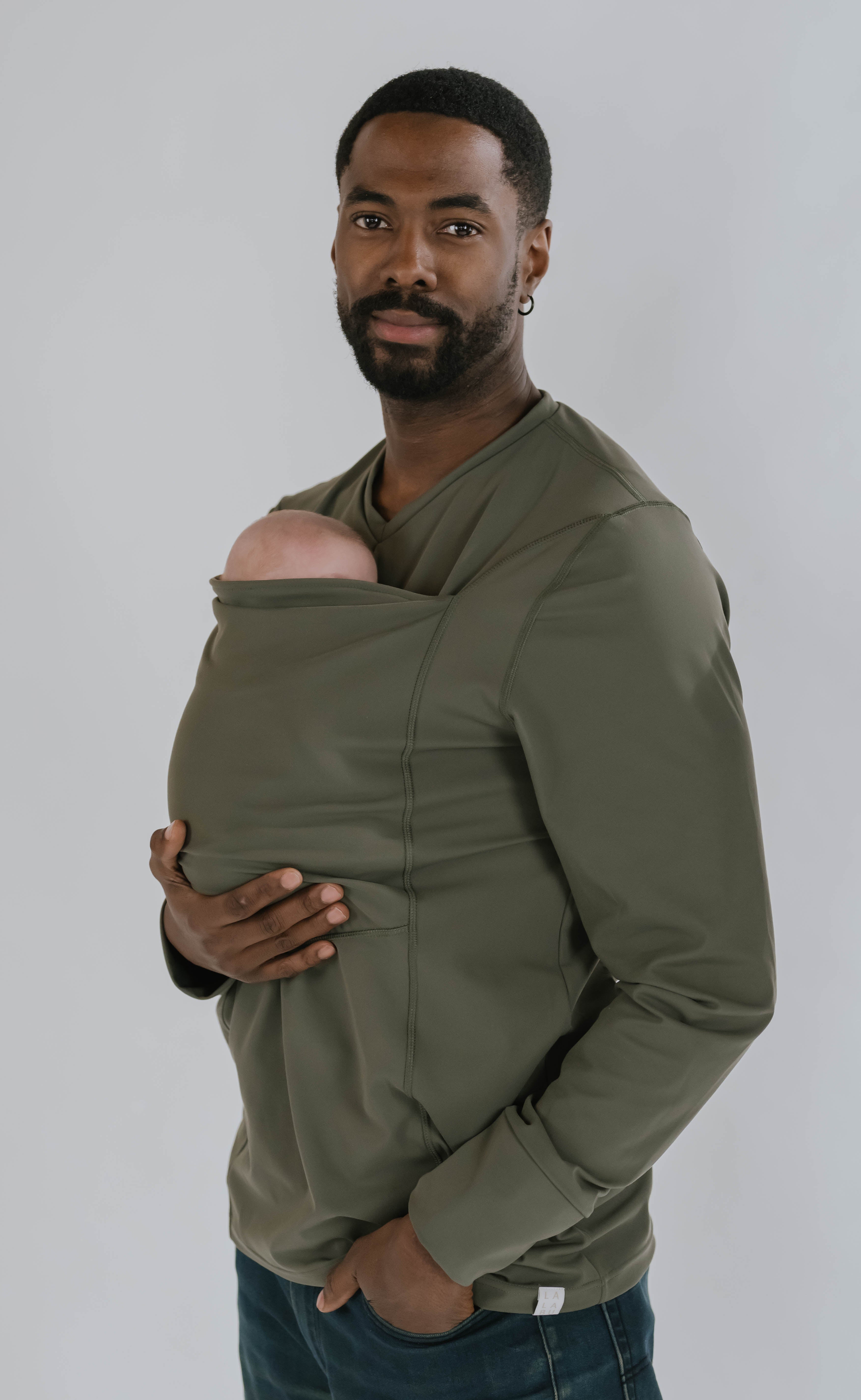 Dad with his hand on the bottom of the baby in the pouch of his Fern long sleeve Dad Shirt.