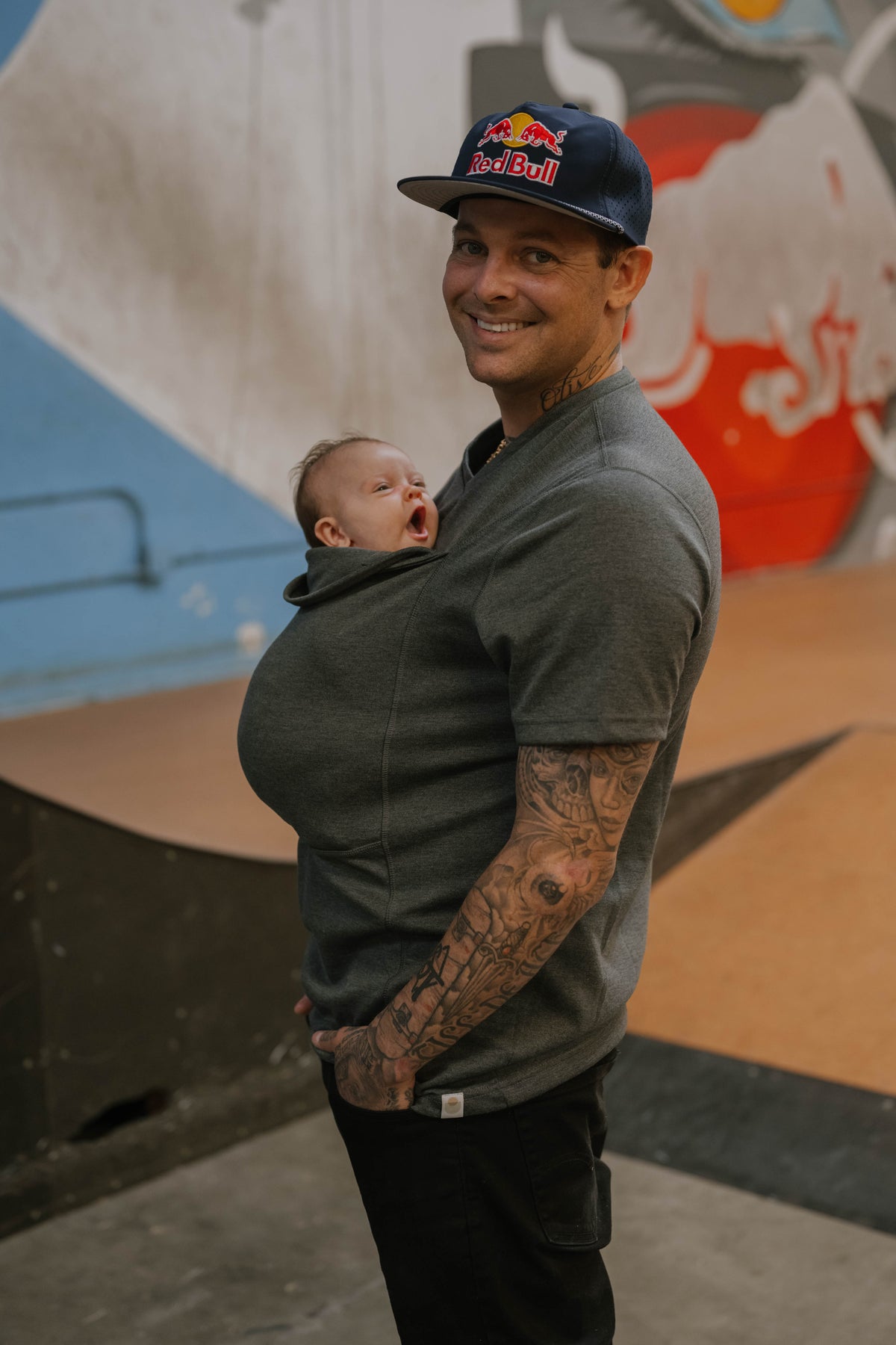 Ryan Sheckler wearing his baby in the Dad Shirt.