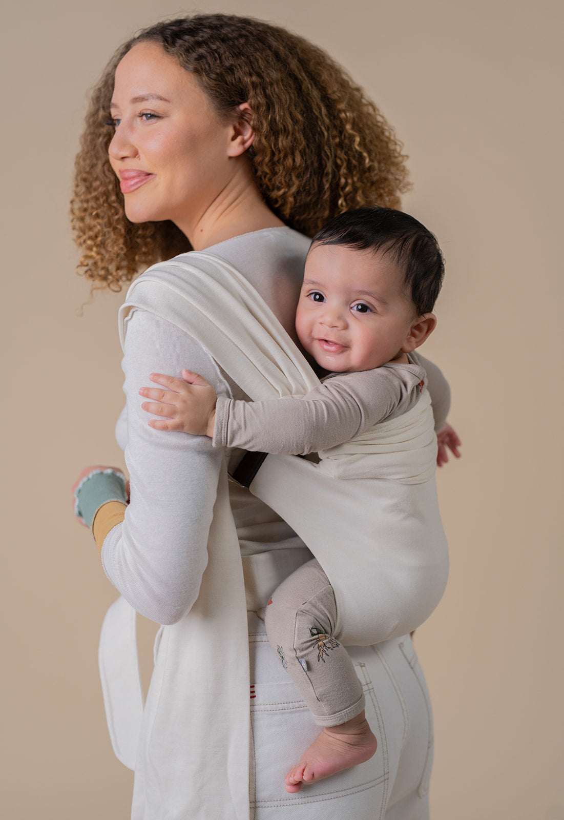 Mom back carrying baby in a Simple Wrap.