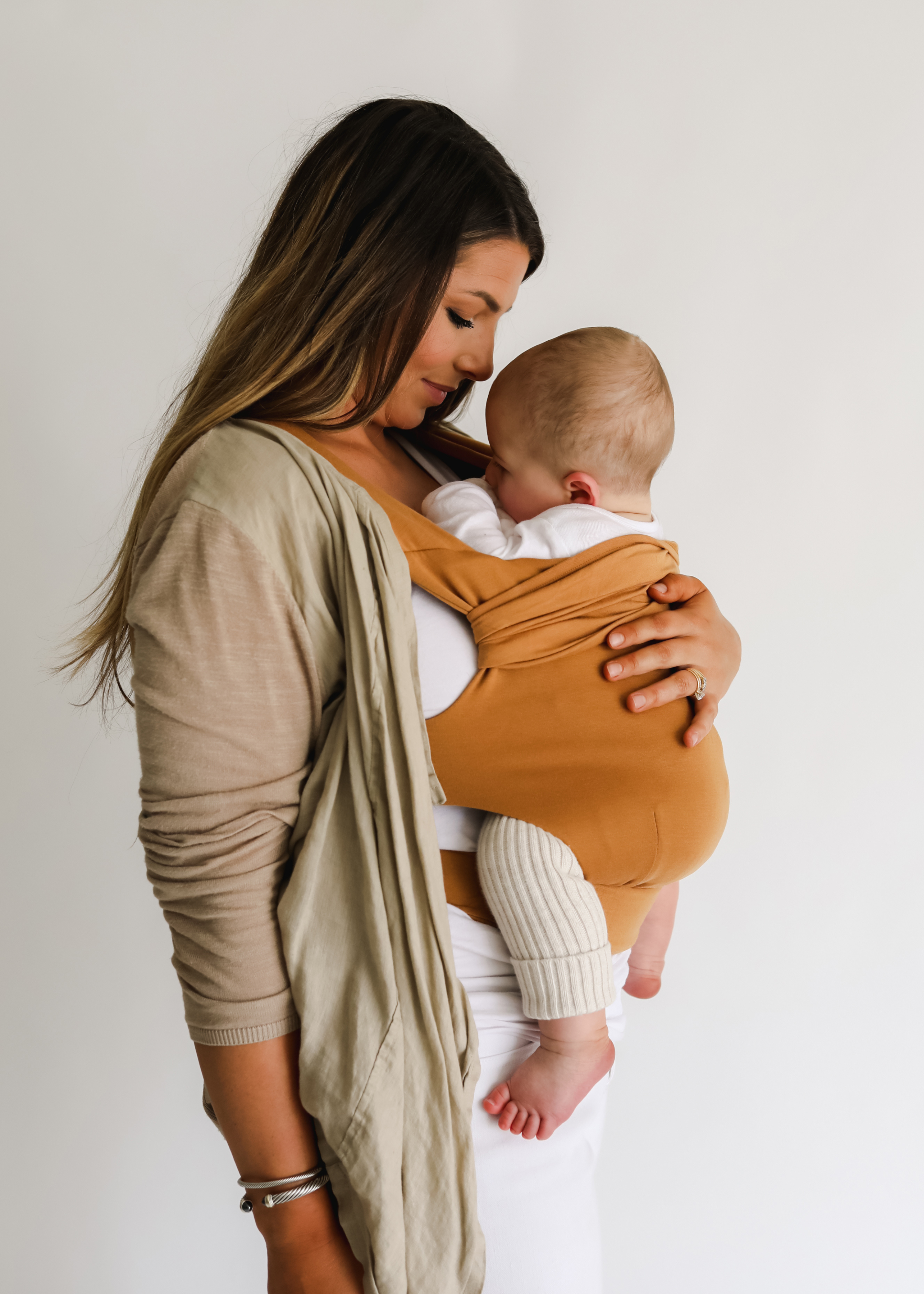 Mom front carrying her baby in a Camel Simple wrap.