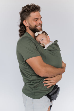 Dad snuggling the newborn in his Dad Shirt.