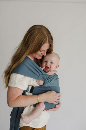 Mom front carrying baby in a simple wrap.