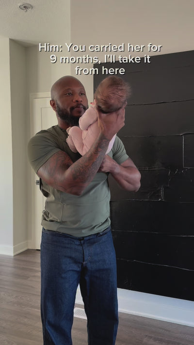 Dad puts baby in the pouch of his Fern Dad Shirt. "Him: You carried her for 9 months, I'll take it from here."