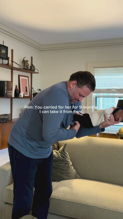 Dad starts his morning putting baby in his Brook Dad Shirt. Delivers coffee and a kiss to his wife.
