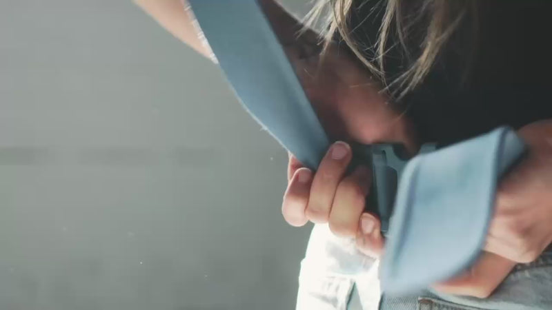 Two moms putting on Simple Wraps and placing their babies into the carrier.