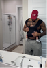 Male puts on a black Simple Wrap, puts his baby inside it and goes about his daily routine.