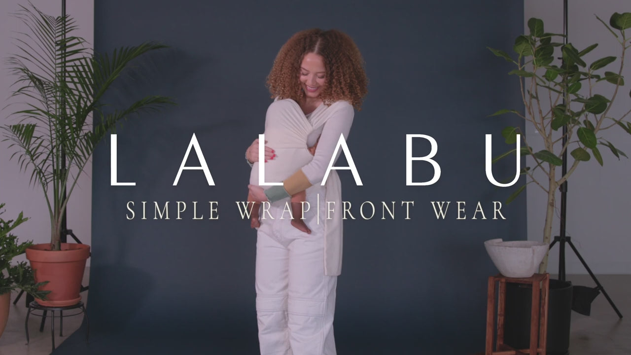 Lalabu Simple Wrap, Front Wear.  Demonstration of threading the straps so they are crossed in the back. Next clipping the waistband on with the appropriate age label facing wearer.  Slipping both straps over the head, putting arms through the straps, then sliding baby in through the top of the carrier. Lastly, tightening the straps so that baby has a nice seat and wearer is comfortable.  The headrest can be raised or lowered. The fabric straps should be spread across the back and shoulders.