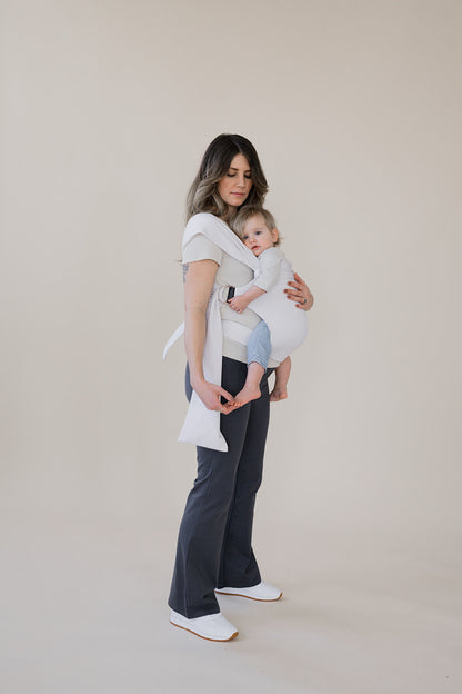 Pregnant female front carrying a baby in an Oatmeal Stripe Simple Wrap.