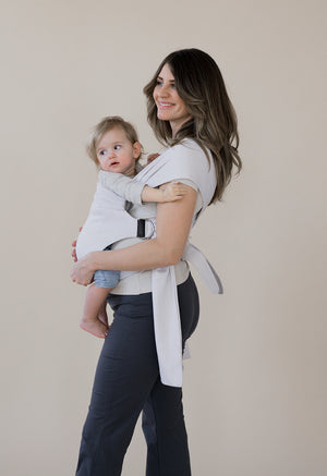 Pregnant female front carrying a baby in an Oatmeal Stripe Simple Wrap.