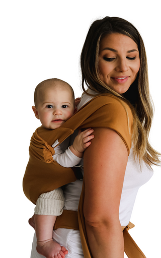 Side view of a female back carrying a baby in a Camel SImple Wrap.