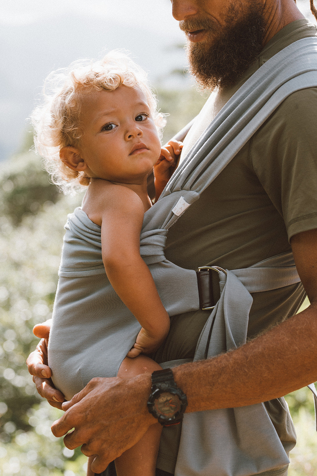 Side view of a male front carrying a toddler in an Ash Simple Wrap.