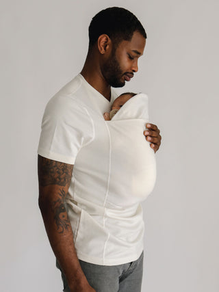 Male wearing a newborn in a Natural Dad Shirt with pouch extender pulled up.