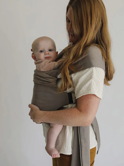 Female front carrying a baby in a Driftwood Simple Wrap.