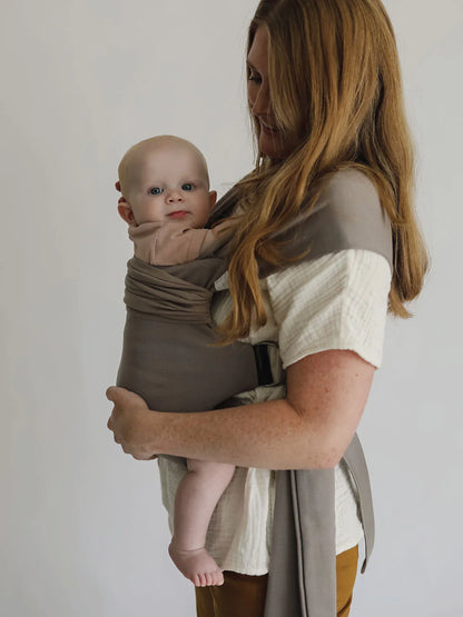 Female front carrying a baby in a Driftwood Simple Wrap.