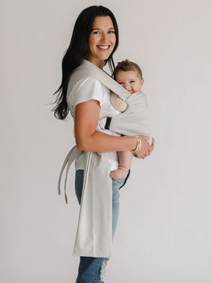 Female front carrying a baby in a Fog Simple Wrap.