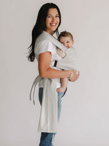 Female front carrying a baby in a Fog Simple Wrap.