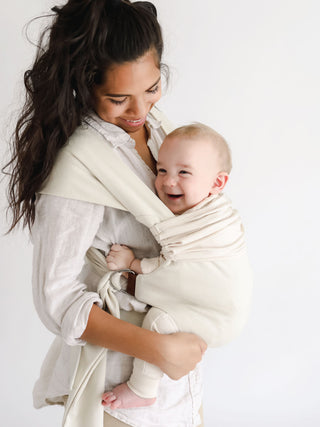 Side view of a female front carrying a baby in a Natural Simple Wrap.