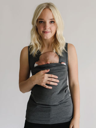 Front view of a female wearing a newborn in a gray Soothe Shirt.