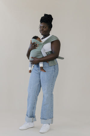 Female front carrying a baby in an Olive Simple Wrap.
